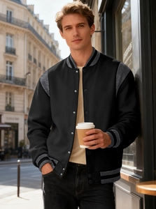 Detail of color-block varsity jacket with striped ribbed collar and metal buttons