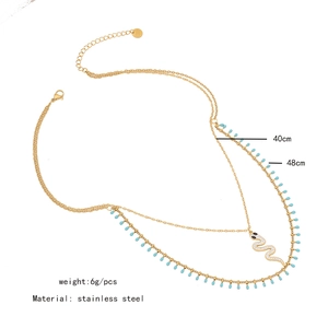 Detailed view of layered gold snake necklace with crystal pavé and dimension specs