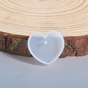 Detailed view of heart-shaped silicone resin mold on a wooden display for DIY crafts