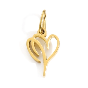 Macro shot of abstract gold heart pendant with polished metal texture on white surface
