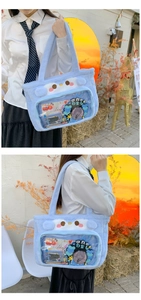 Detail of light blue plush tote bag with clear window and cute cartoon cat ear design