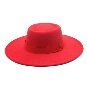 Detail view of red wide brim wool felt hat with matching silk ribbon and elegant side knot