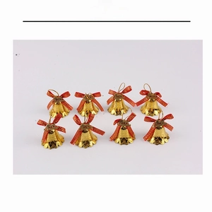 Detailed view of 8 gold Christmas bells with red Merry Christmas bows for tree decor