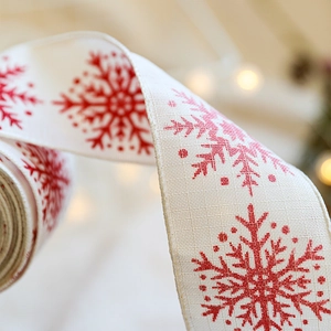Christmas burlap ribbon with red snowflake prints for holiday gift wrapping and DIY decor
