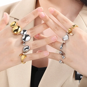 Minimalist 18K gold and silver irregular fluid rings worn on a model's hand