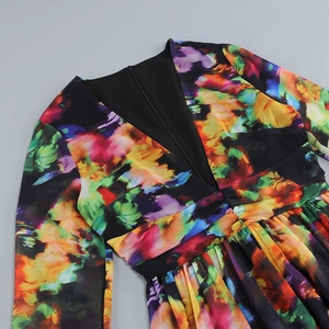 Detail view of colorful abstract print dress featuring deep V-neck and ruched waist design