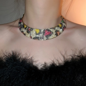 Close-up of leopard pattern collar necklace with colorful rhinestones on a golden base