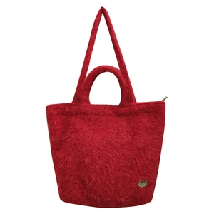 Red plush tote bag with heart charm and versatile shoulder straps on white background
