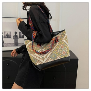Detail of bohemian tote bag featuring colorful geometric patterns and wide ethnic strap