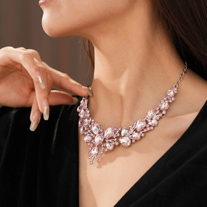 Detail of pink crystal droplet flower necklace on model with elegant choker design