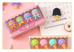 Close-up of cute lollipop and ice cream shaped erasers set in a pastel gift box