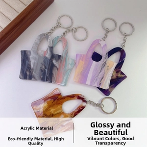 Detailed view of colorful marble texture acrylic handbag charms with silver metal keychains