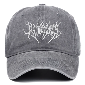 Detail of gothic embroidery on washed cotton vintage style distressed baseball cap
