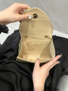 Elegant gold glitter evening clutch bag with magnetic closure and beige interior lining