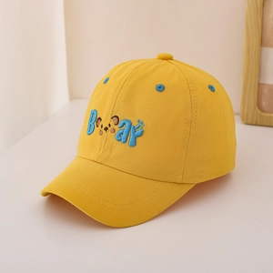 Close-up of Bear letter embroidery and claw motif on yellow cotton kids baseball cap