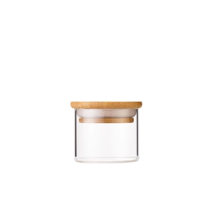 Portable mini glass tea canister with airtight bamboo lid on white background