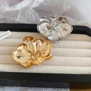 Vintage orchid flower brooches in gold and silver metal with textured hammered petals