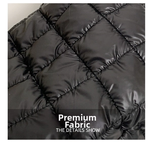 Detailed macro view of black quilted fabric with glossy finish and square stitching