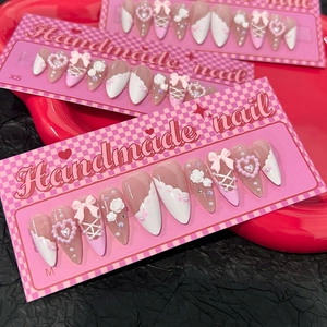 Pink and white French press-on nails with 3D camellia flowers, bows, and pearls