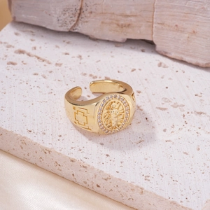 Golden Virgin Mary embossed open ring with zircon halo on minimalist stone display