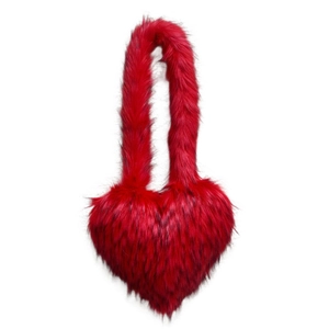 Detail view of heart-shaped faux fur bag in vibrant red with long plush shoulder straps