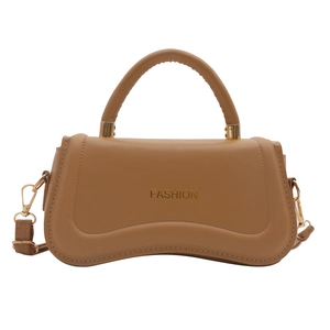 Minimalist tan leather handbag with wavy bottom and gold Fashion text on white background