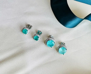Detail of 925 silver stud earrings with 8mm round Paraiba stone and pavé halo setting