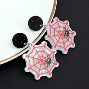 Détail macro de boucles d'oreilles toile d'araignée d'Halloween sur plat céramique