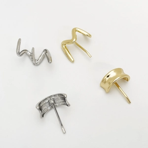 Detailed view of four alloy hair clips in gold and silver with wavy and curved designs