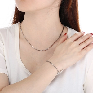 Polished stainless steel long box chain necklace and bracelet set worn by a model