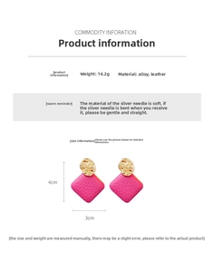 Detailed specs of irregular fuchsia leather drop earrings with golden hammered metal