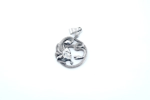 Macro shot of silver titanium Medusa pendant featuring intricate snake details and textures