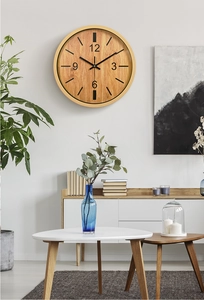 Modern 12-inch bamboo texture wall clock displayed in a minimalist living room setting