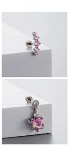 Detailed macro view of pink zircon heart pendant and curved five-diamond stud earrings
