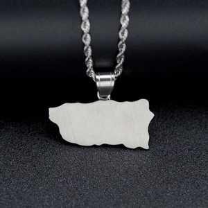Silver stainless steel world map pendant necklace with twisted rope chain on black surface