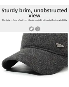 Macro detail of dark grey wool winter cap featuring a metal sports badge and stiff brim