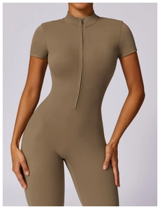 Detail view of khaki yoga jumpsuit featuring short sleeves and front half-zipper closure