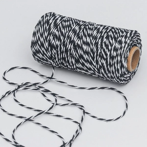 Detailed close-up of black and white braided cotton twine rope for DIY gift wrapping