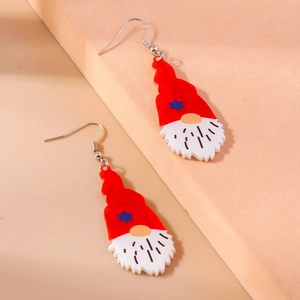 Detail shot of acrylic Christmas gnome earrings with red hats and star patterns