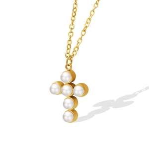 Elegant gold necklace with a cross pendant made of white pearls on white background