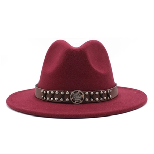 Classic burgundy wool fedora hat with brown leather rivet band on white background