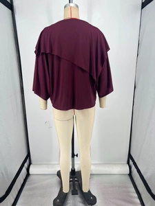 Detail of the back view of dark purple loose tunic with asymmetrical layered drape design