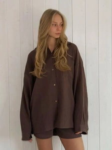 Detail of long-sleeved brown muslin shirt set with natural crinkle texture and buttons