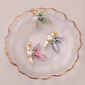Detailed shot of gold hummingbird pendants with gradient wings and white zircon inlays