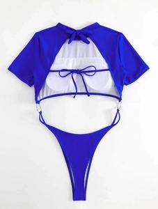 Detail of royal blue one-piece swimsuit featuring backless design with chic bow ties