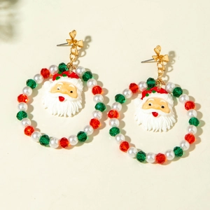 Detailed shot of Christmas earrings featuring beaded rings and Santa Claus charms