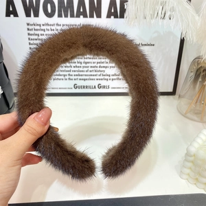 Detail of dark brown plush headband showing thick faux mink fur texture and soft feel