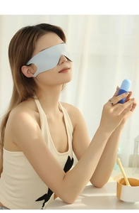 Close-up of a soft light blue sleep mask and matching portable storage capsule case