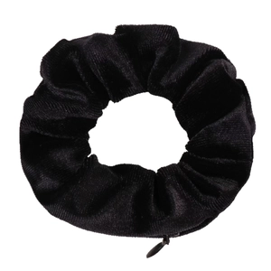 Black velvet scrunchie with hidden zipper pocket for small storage on white background