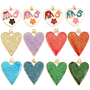 Set of twelve colorful heart-shaped pendants with gold trim and glitter zircon finish